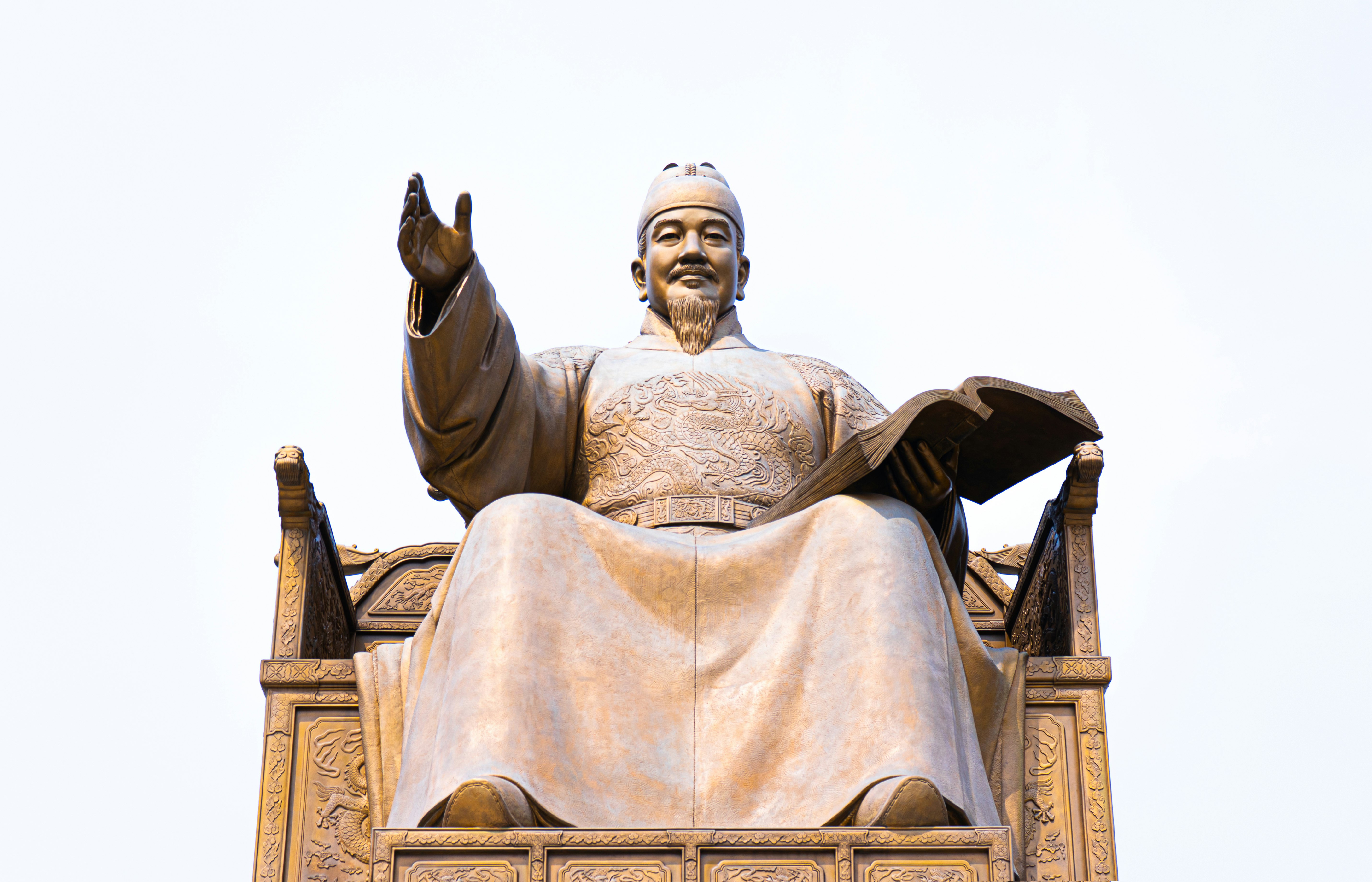 grey concrete statue under white sky during daytime